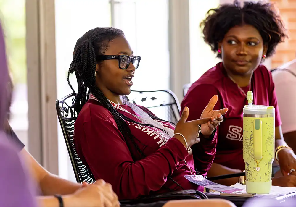 Students talk and share ideas during a small group discussion session.